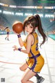 A girl in a yellow and purple uniform holding a basketball.