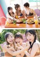 A group of young women sitting at a table eating food.