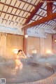 A woman in a bikini standing in a hot tub.